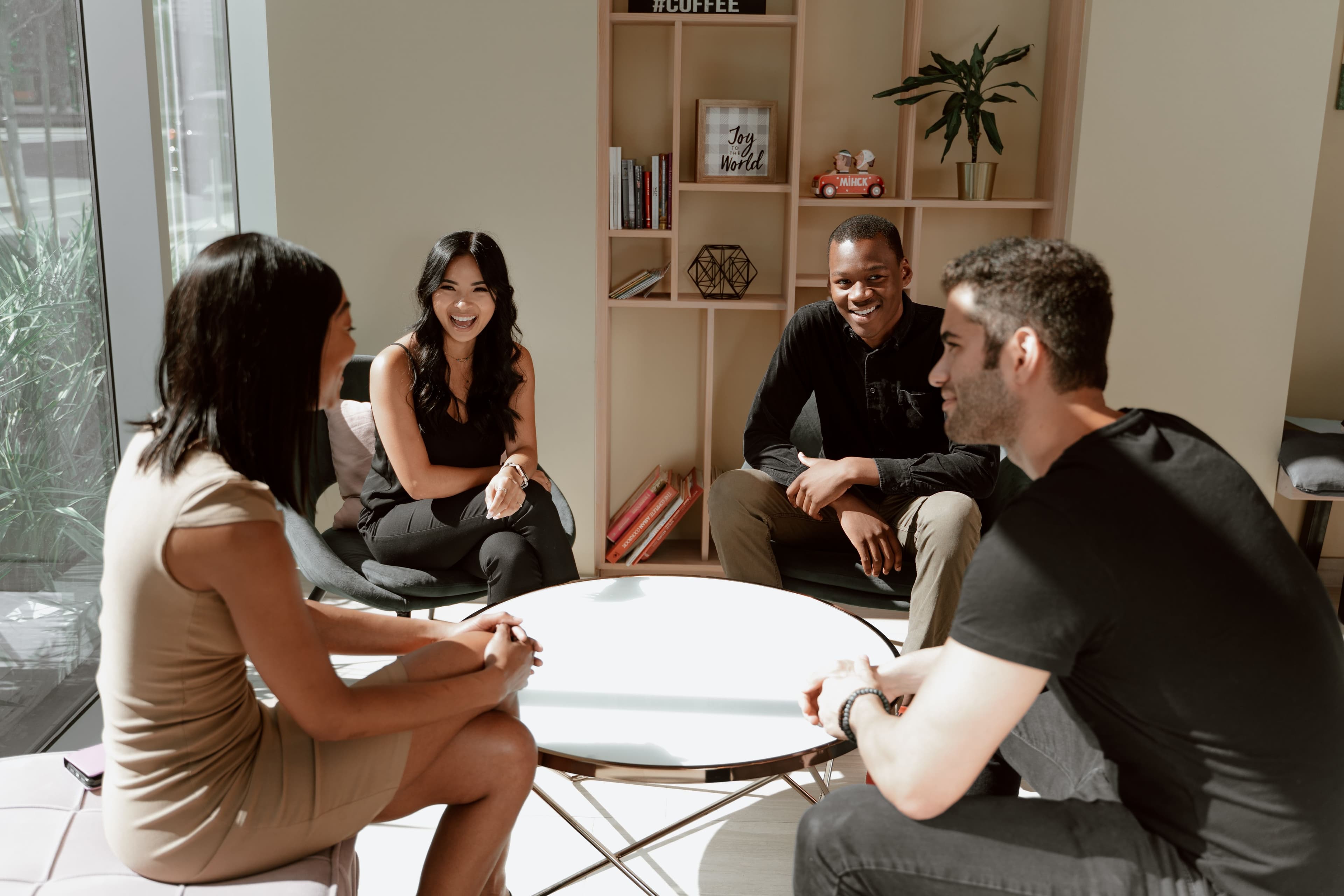 Business leaders networking over coffee around a table
